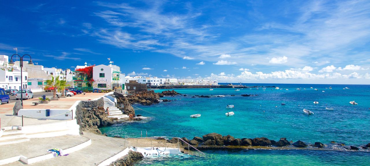 Turquoise waters and whitewashed village in Lanzarote